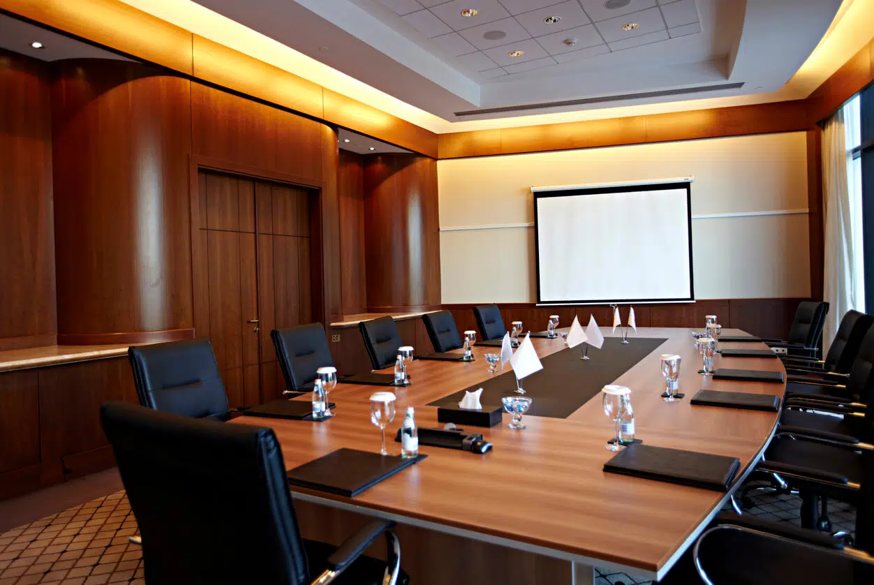 California business dispute lawyer reviewing litigation hold requirements in a corporate conference room.
