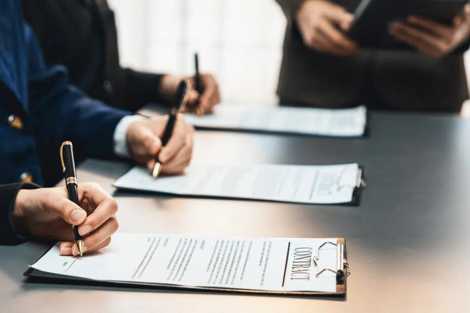corporate executives reviewing legal documents in boardroom