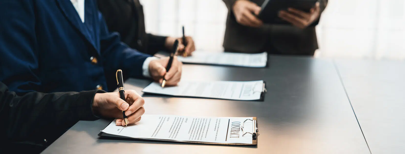 corporate executives reviewing legal documents in boardroom