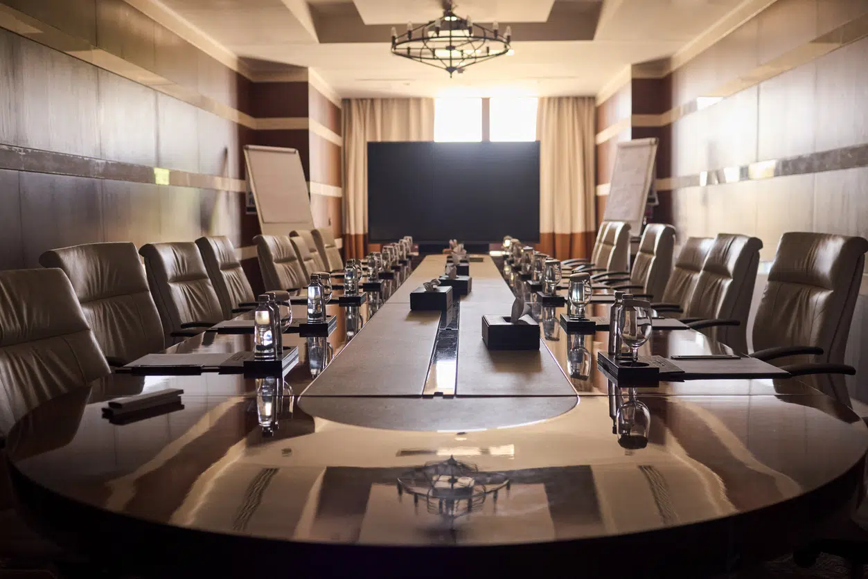Luxurious executive boardroom setup highlighting corporate partnership dissolution, structural separation contracts, and asset division.