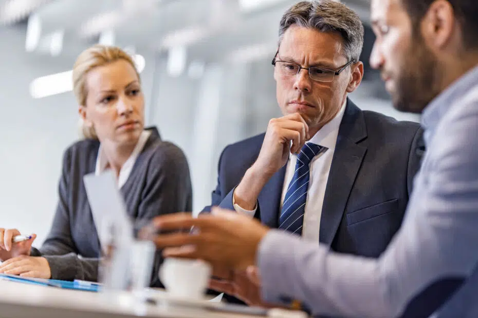 Corporate executives in a boardroom reviewing a sudden data exposure liability crisis.