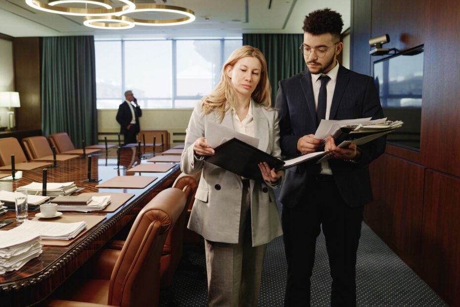 Los Angeles business litigation attorneys reviewing corporate defense documents in a law firm boardroom.