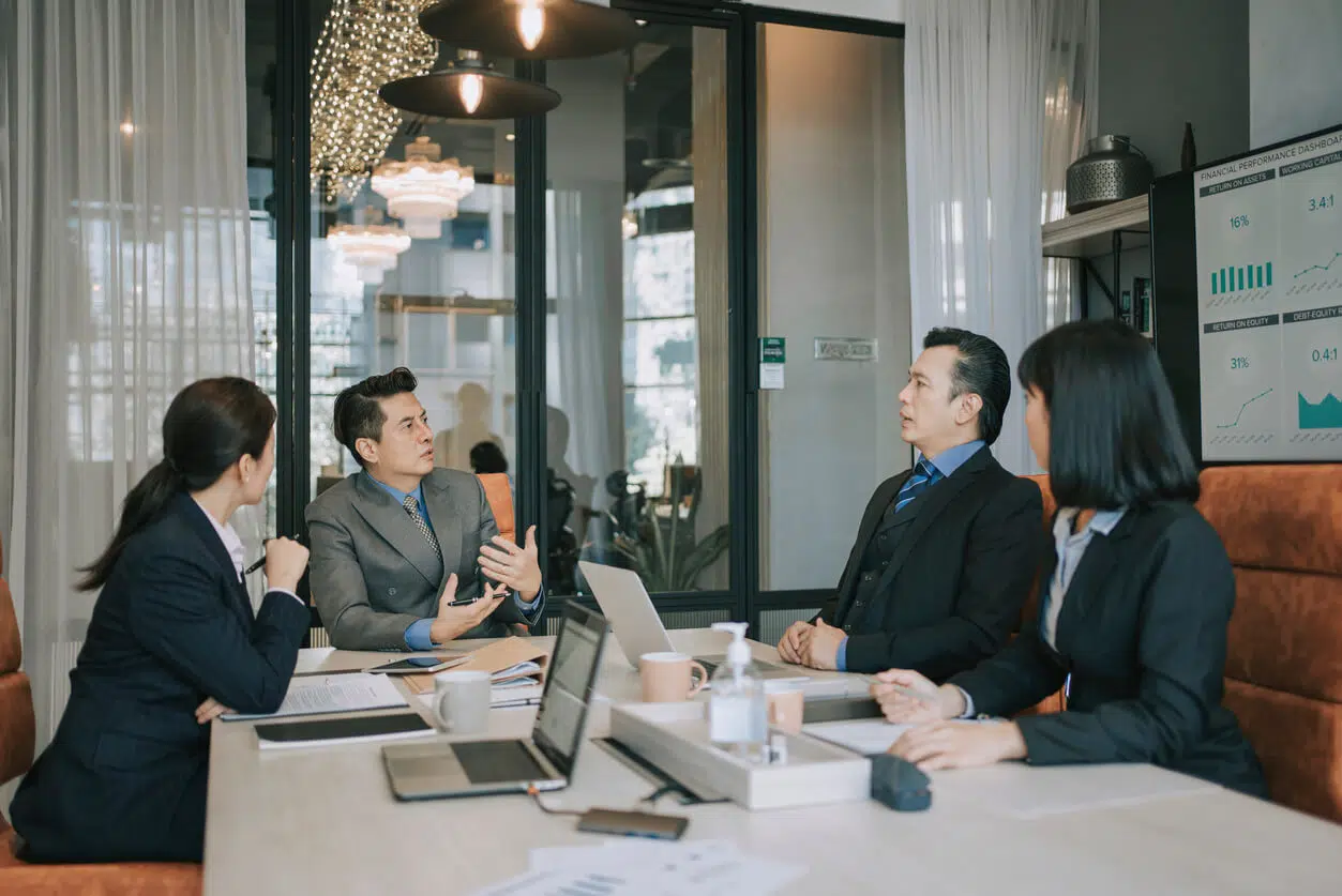 Corporate executives in a high-end boardroom experiencing an argument and contract dispute over uncontracted business collaboration rights.