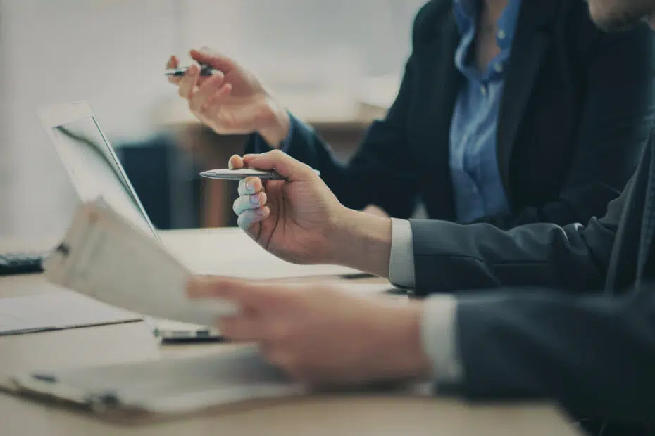 Corporate legal compliance team tracing contractual line items during an analytical business review.