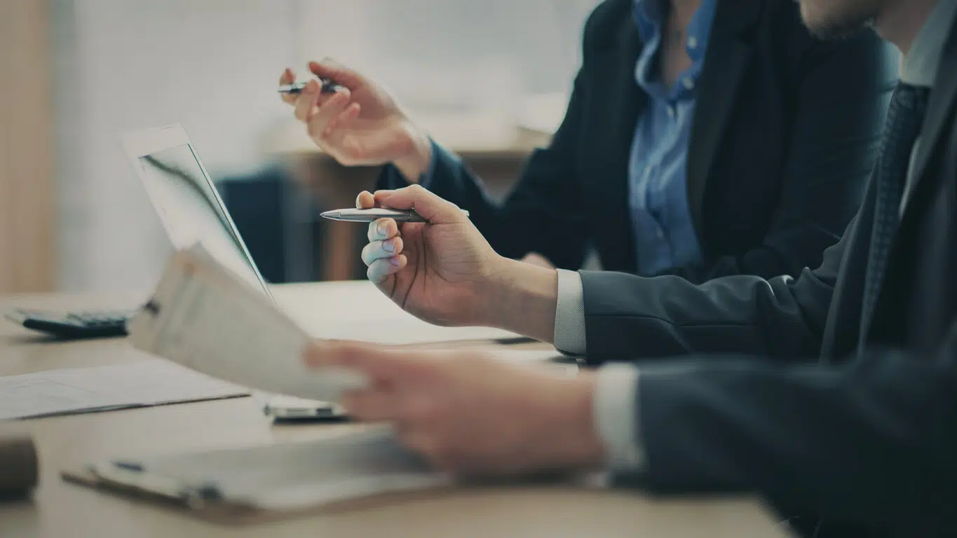 Corporate legal compliance team tracing contractual line items during an analytical business review.